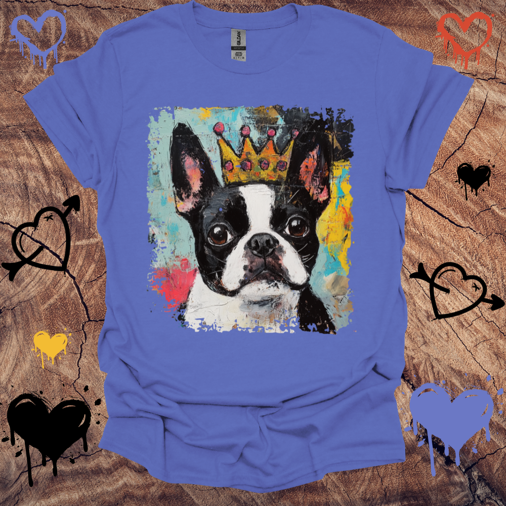 Blue t-shirt with a Boston Terrier wearing a crown graphic on a wooden surface.