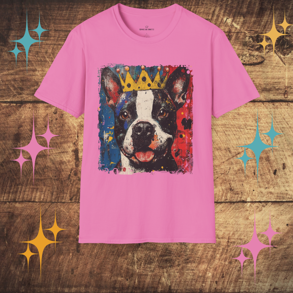 Pink t-shirt with a Pit Bull graphic and crown on a wooden surface with decorative stars.