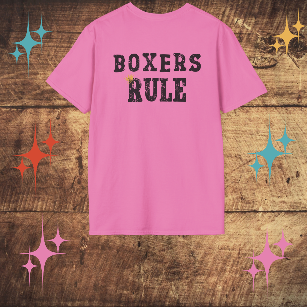Pink t-shirt with 'BOXERS RULE' text on a wooden surface with decorative stars.