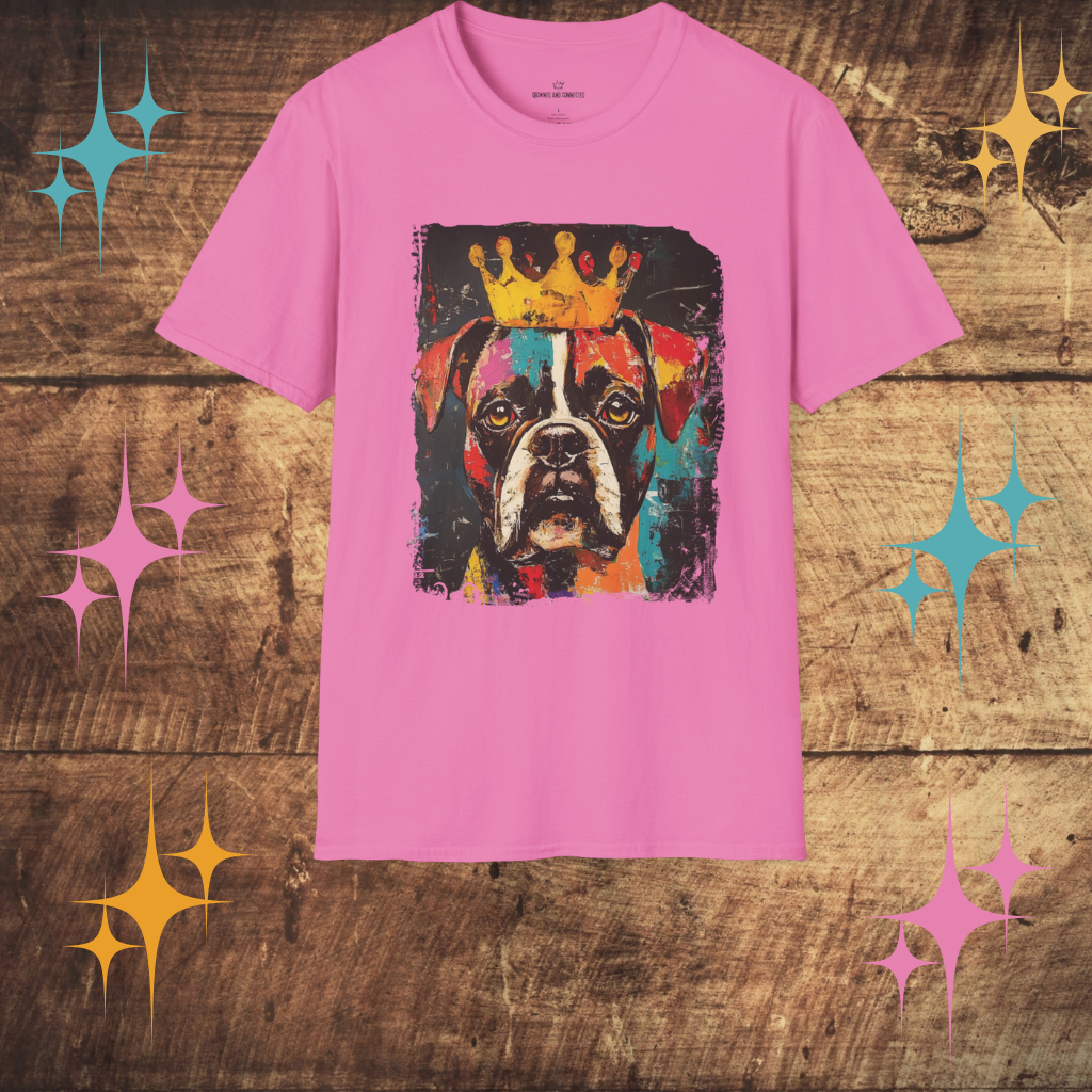 Pink t-shirt with a colorful  bOXER dog graphic and crown on a wooden surface with decorative stars.