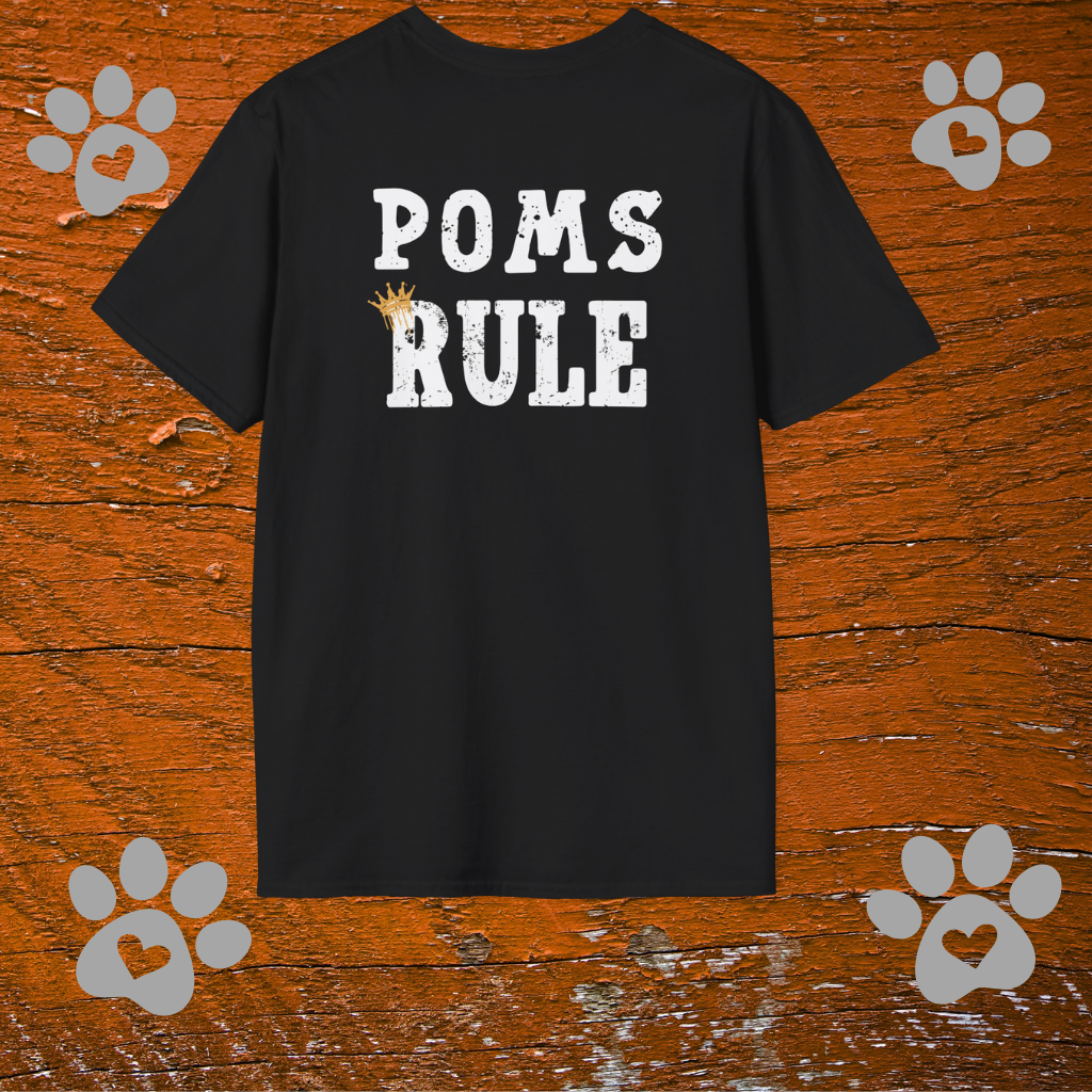 Black t-shirt with 'POMS RULE' text on a wooden background with paw prints.