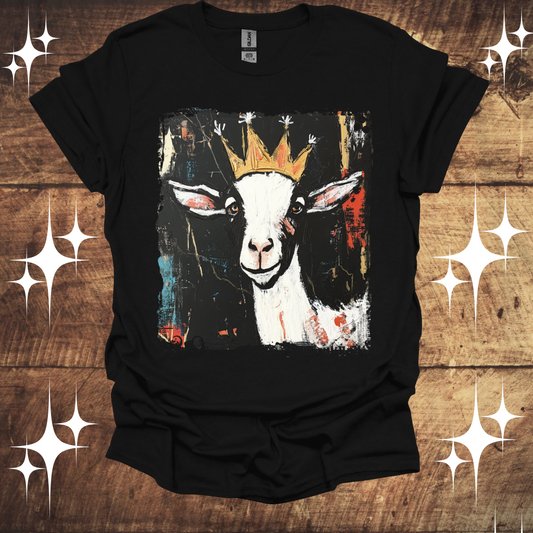 Black t-shirt with a goat wearing a crown design on a wooden background