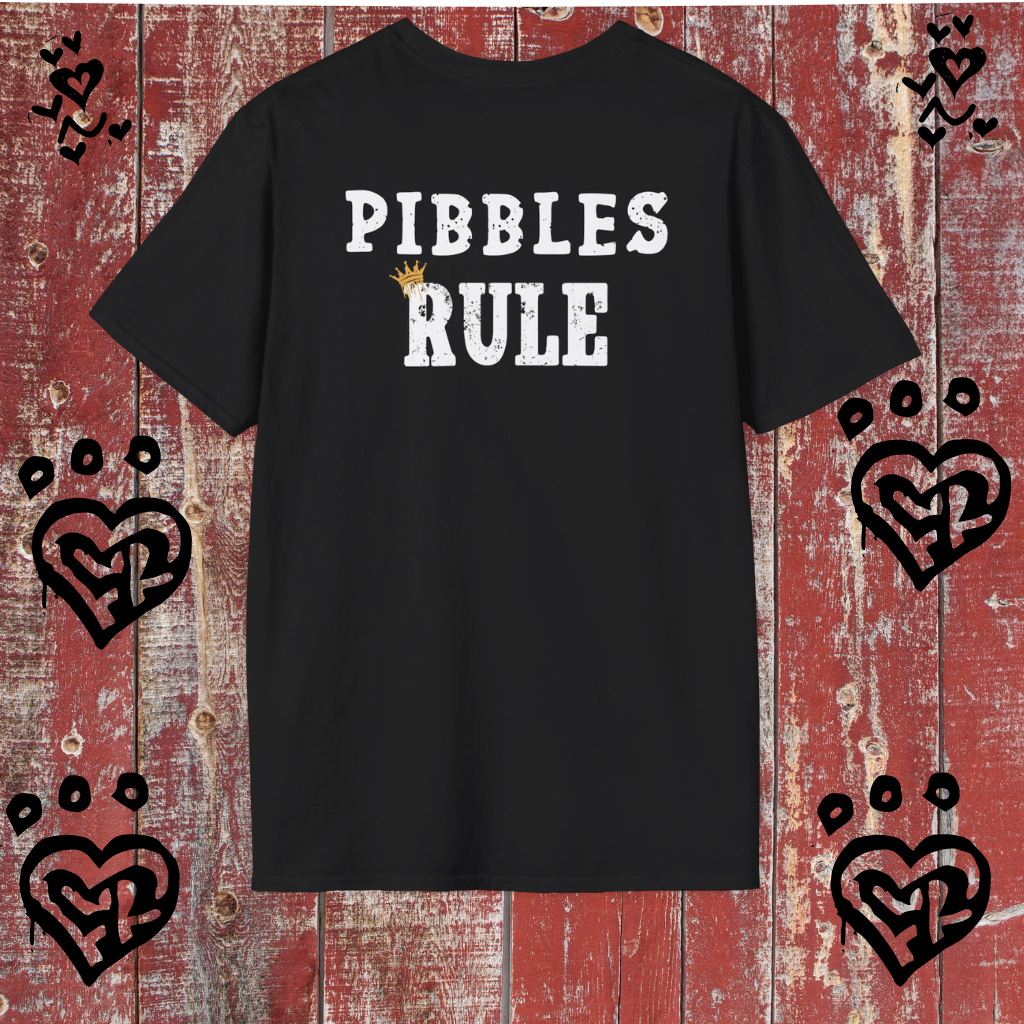 Black t-shirt with 'PIBBLES RULE' text on a red wooden background with heart designs.