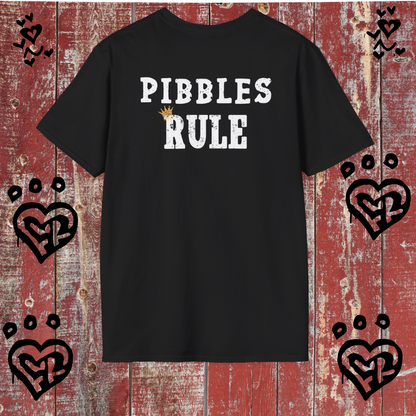 Black t-shirt with 'PIBBLES RULE' text on a red wooden background with heart designs.